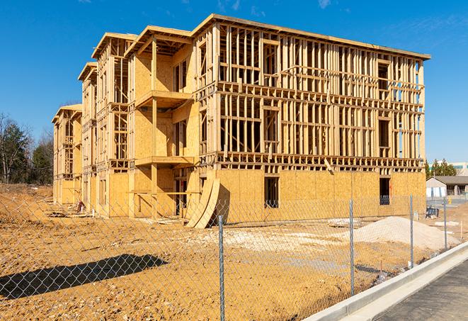 a close-up of temporary chain link fences enclosing a job site, signaling progress in the project's development in Latonia, KY